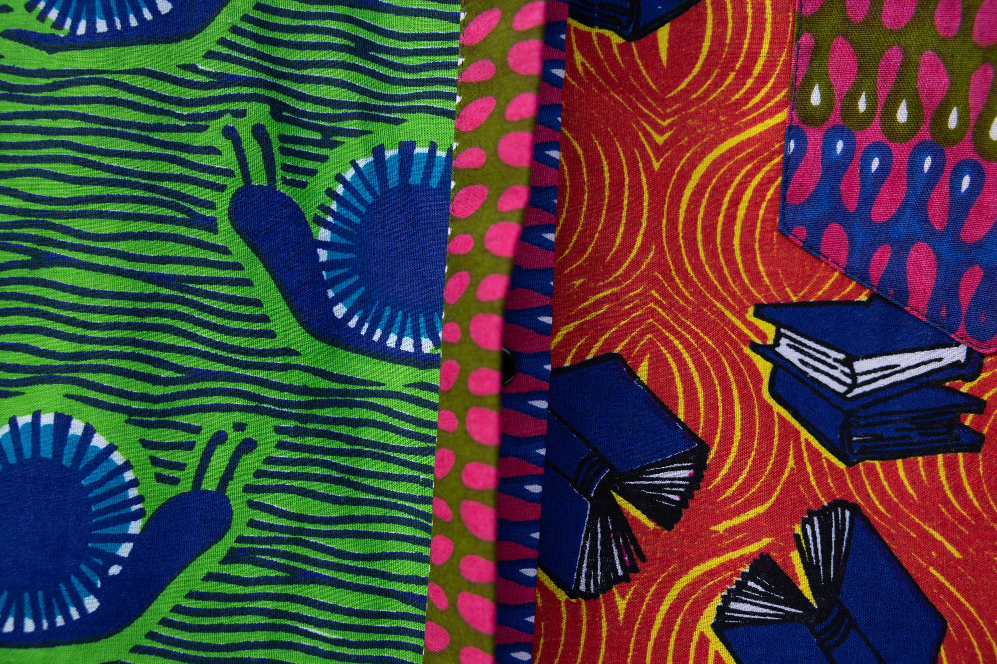 Close up display of green, orange and pink multiprint shirt.