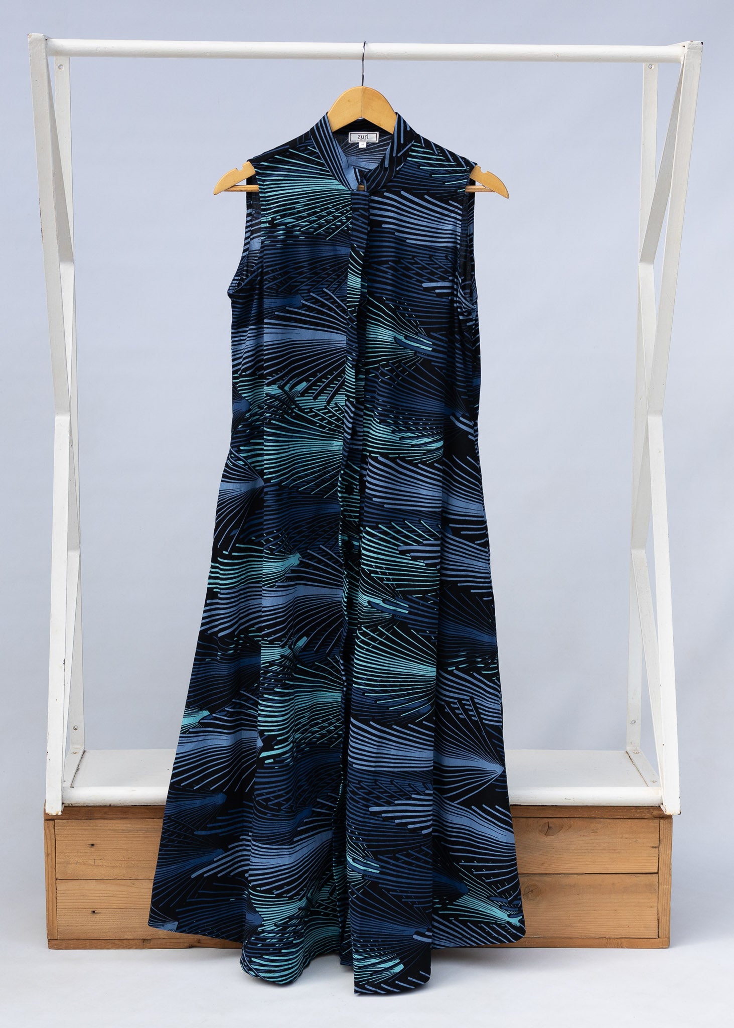 Display of black dress with aqua and navy abstract print.