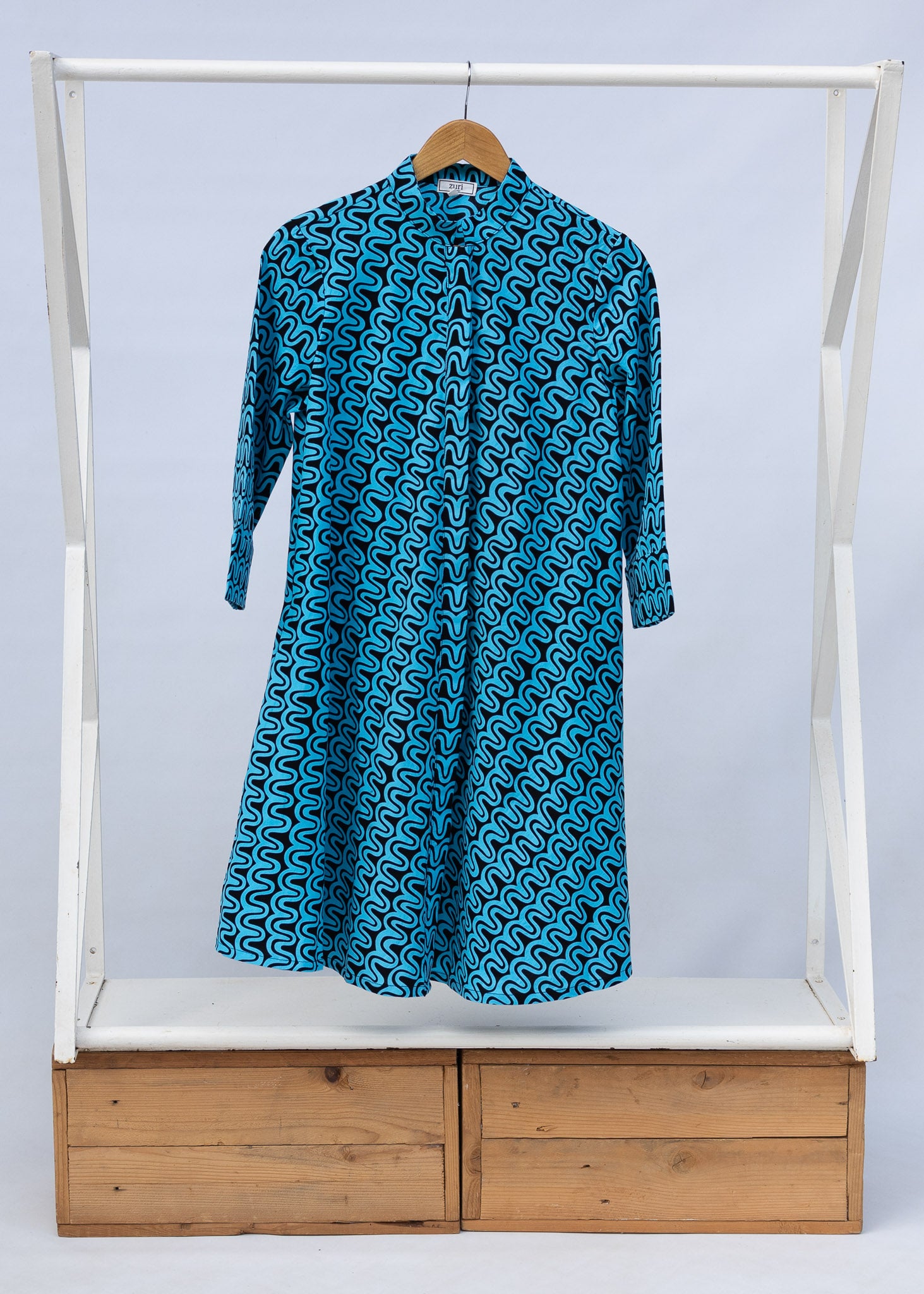 Display of blue and black squiggle print dress.