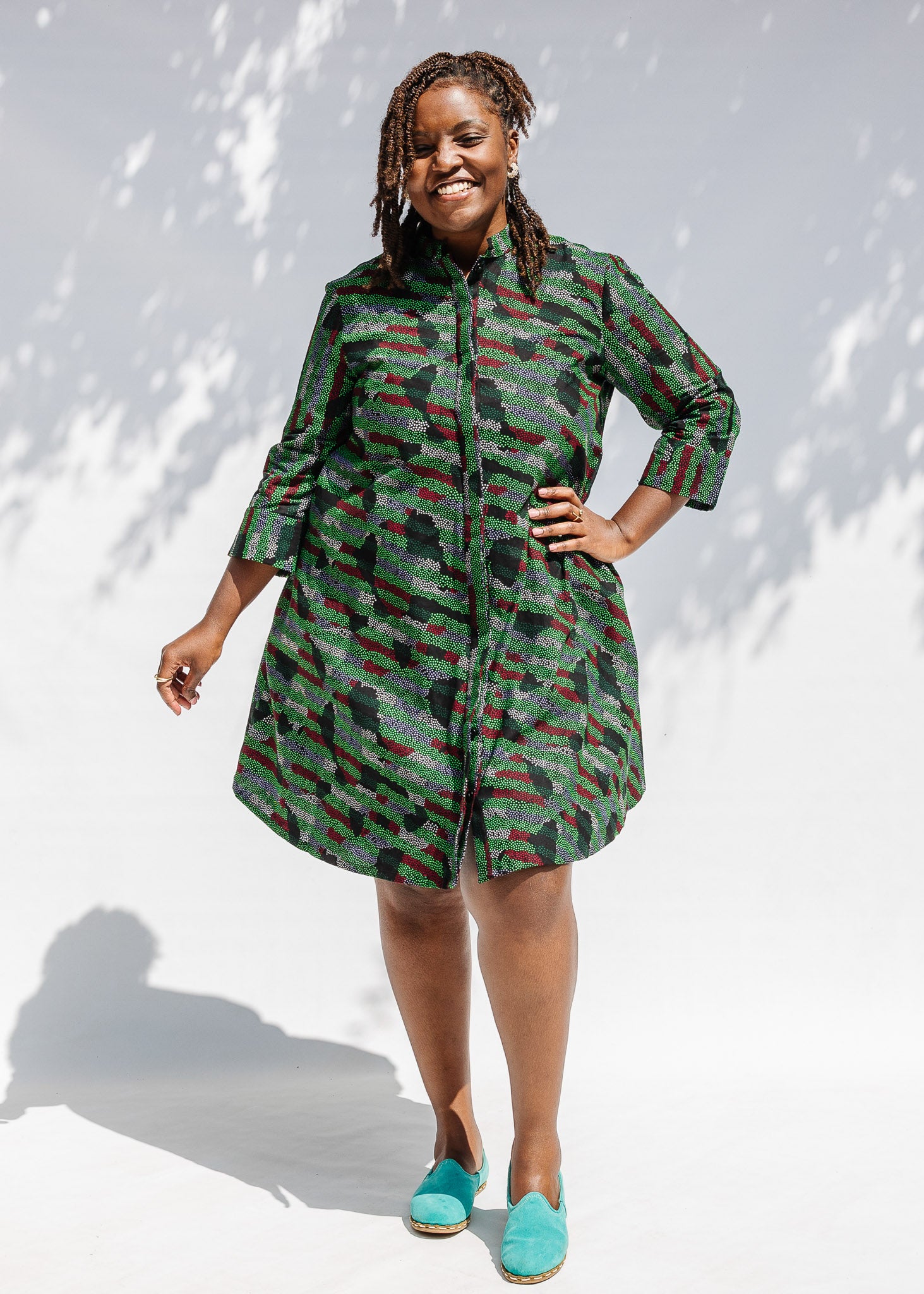 Model wearing green camo print like dress.