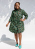 Model wearing green camo print like dress.
