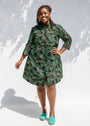 Model wearing green camo print like dress.