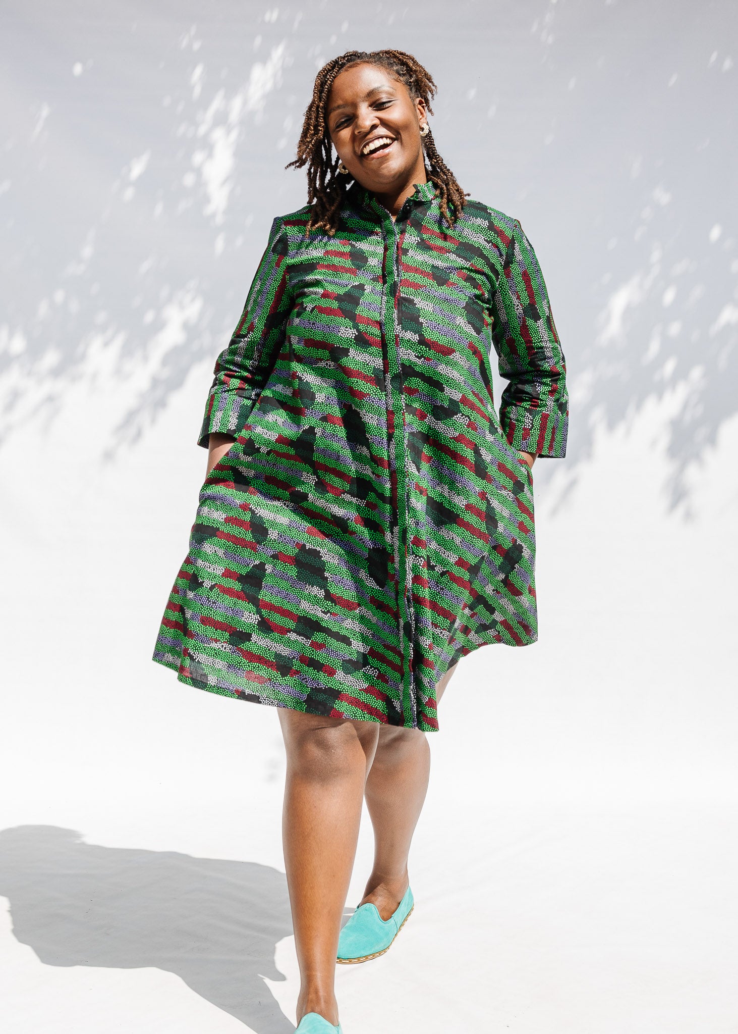 Model wearing green camo print like dress.