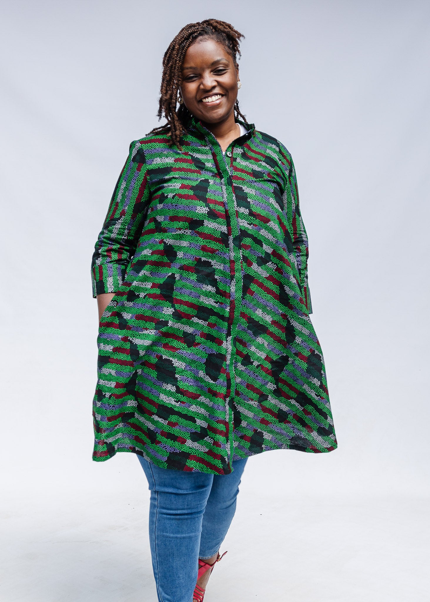Model wearing green camo print like dress.