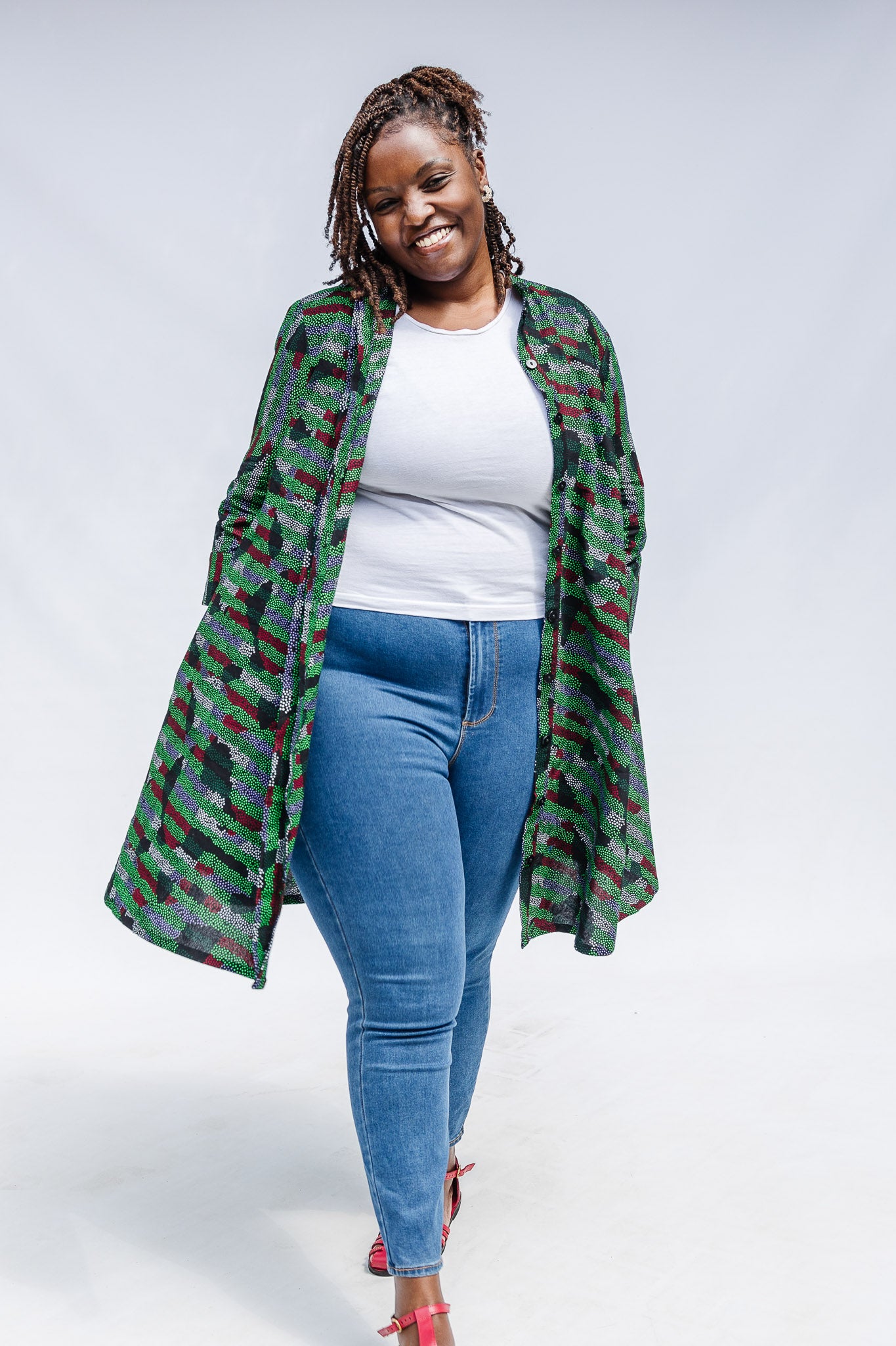 Model wearing green camo print like dress.