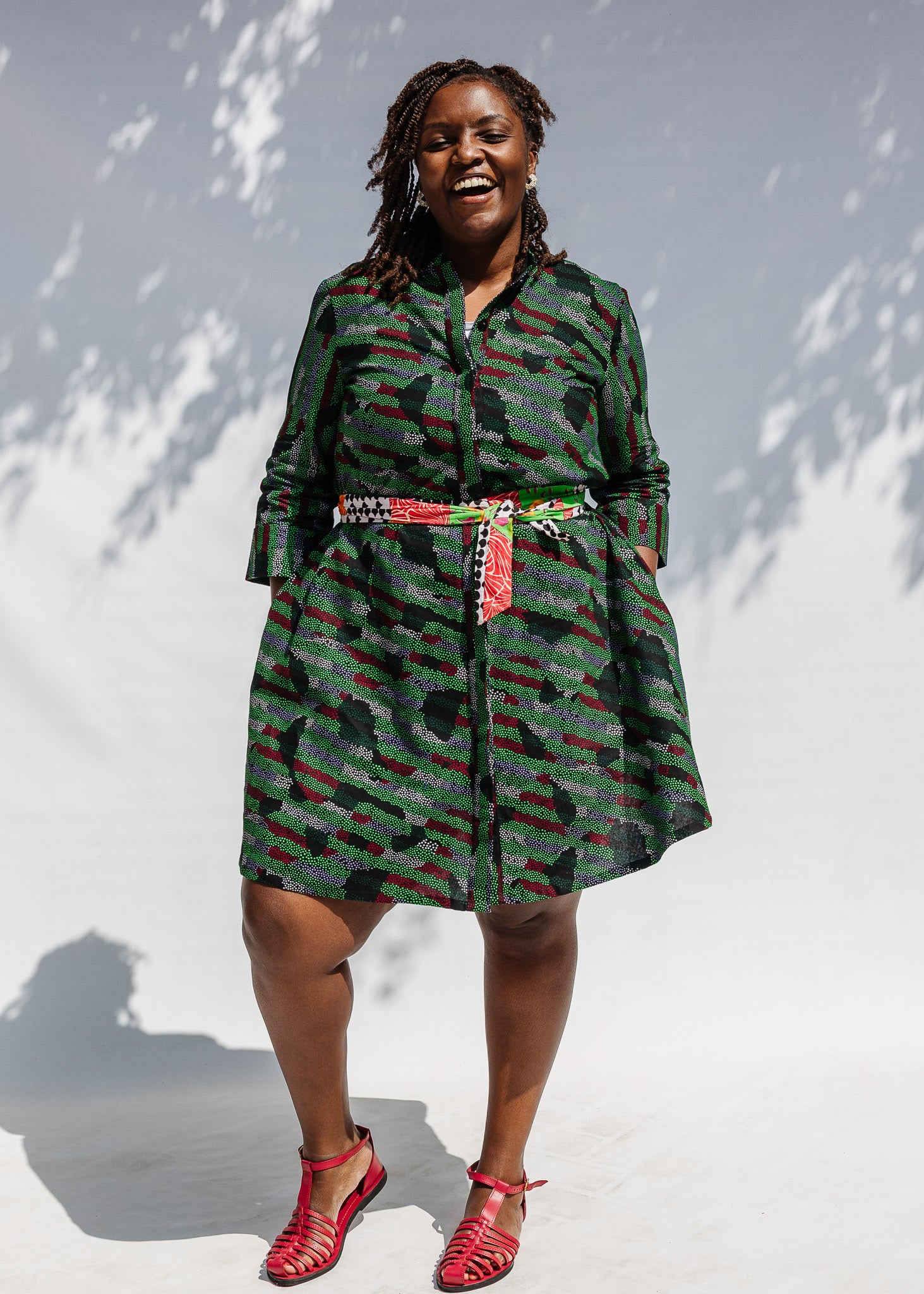 Model wearing green camo print like dress.