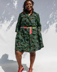 Model wearing green camo print like dress.