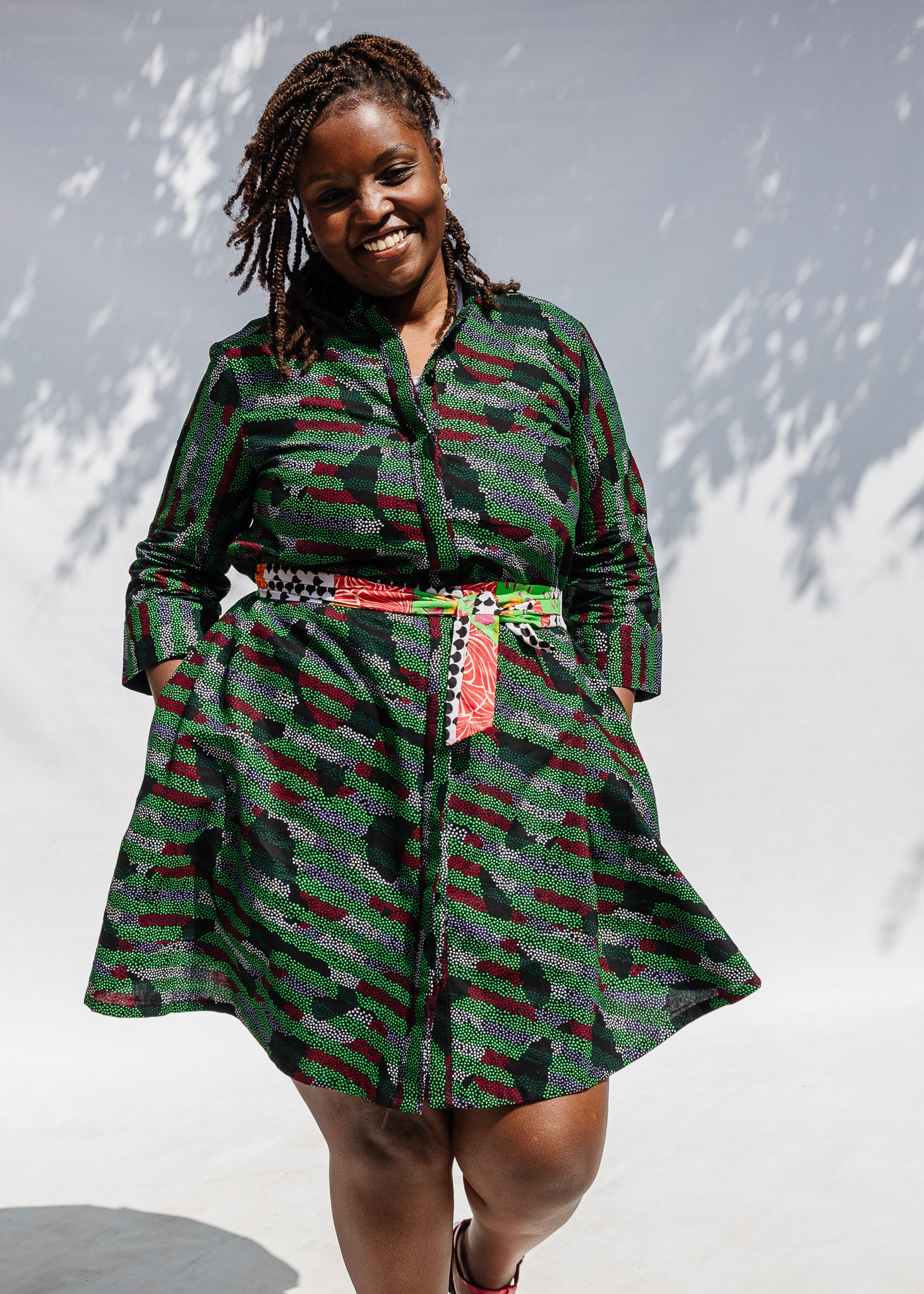 Model wearing green camo print like dress.