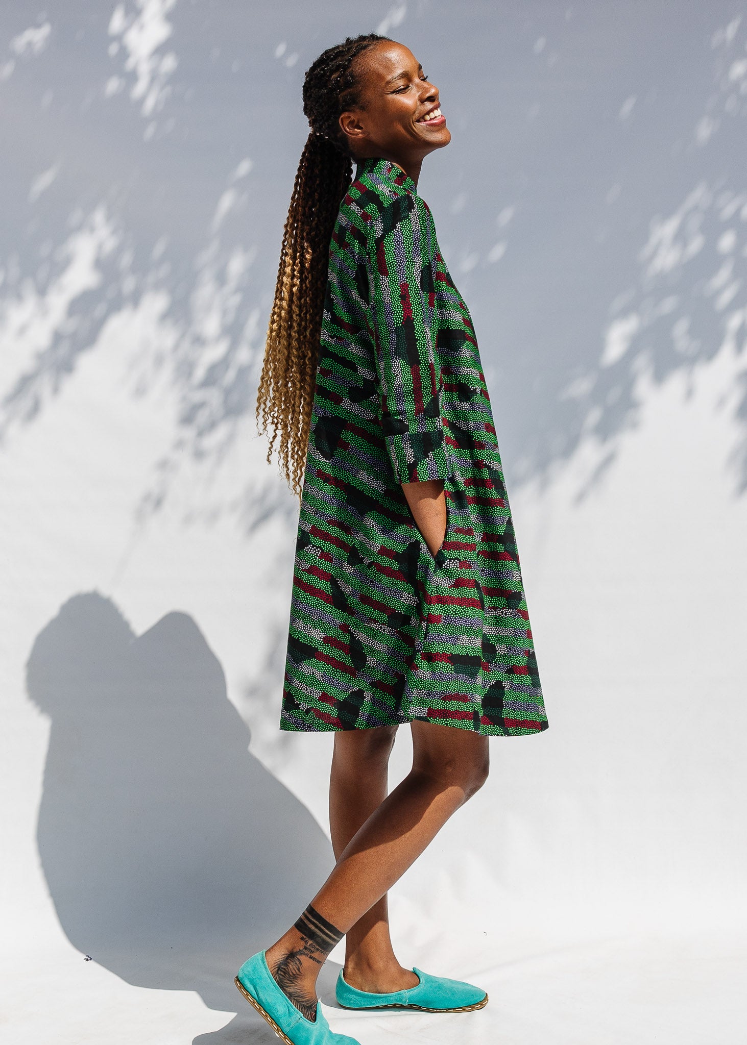 Model wearing green camo print like dress.