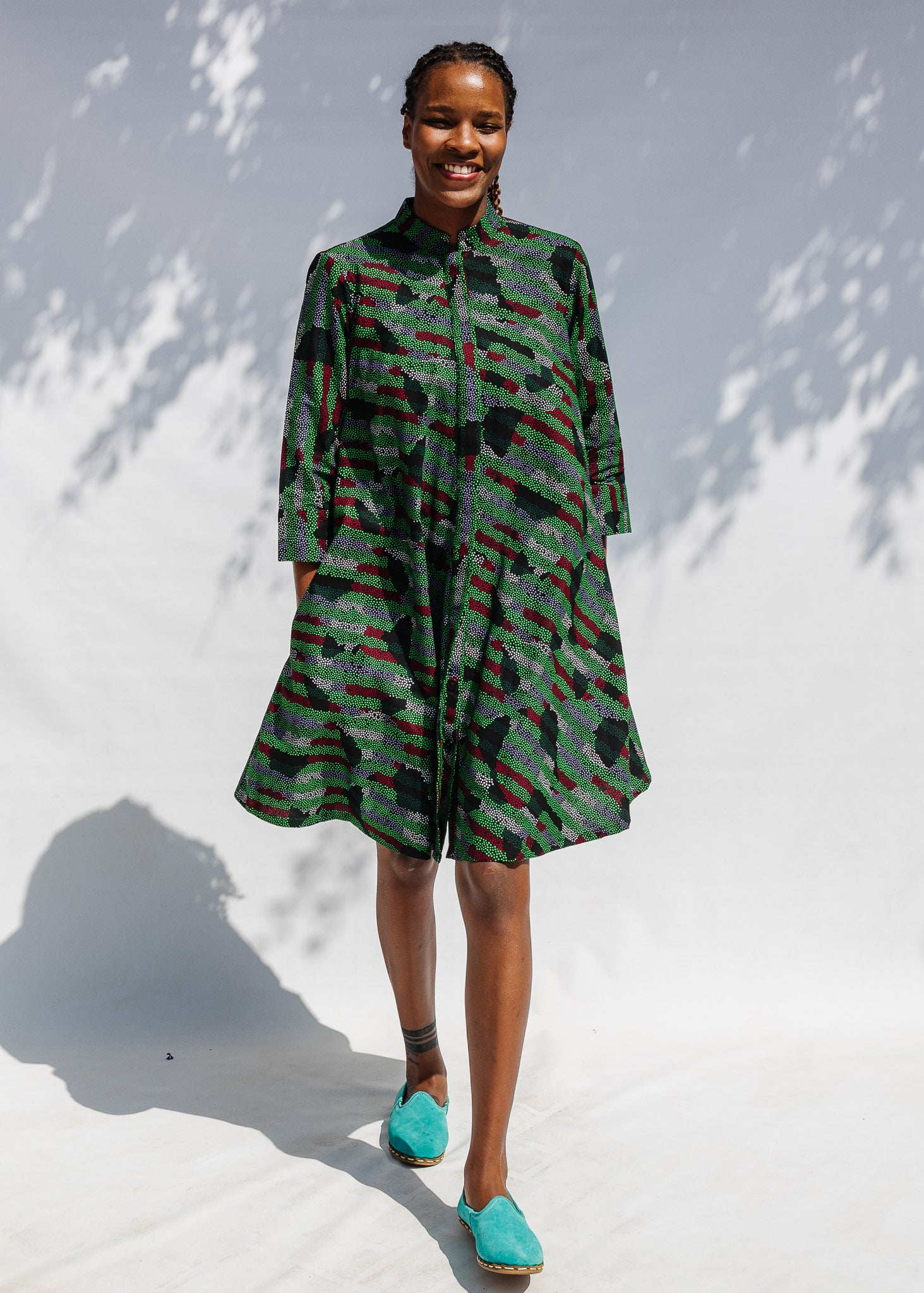 Model wearing green camo print like dress.