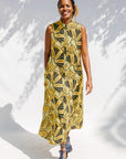 Model wearing yellow and black sleeveless maxi dress.