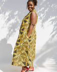 Model wearing yellow and black sleeveless maxi dress.