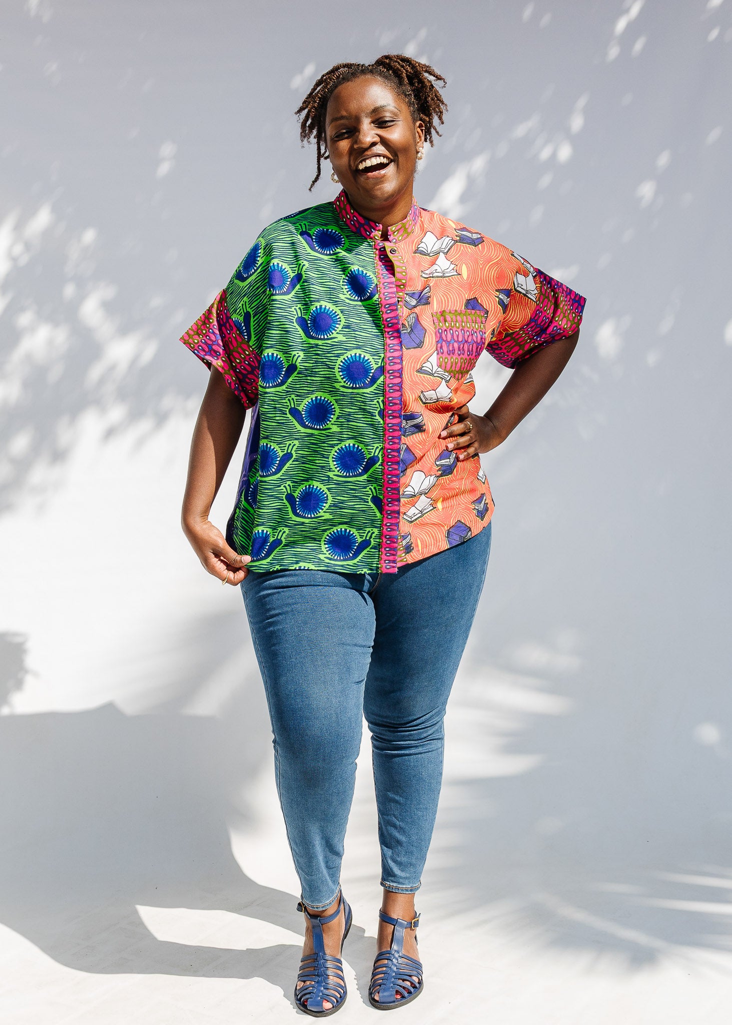 Model wearing green, orange and pink multiprint shirt.
