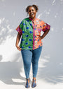 Model wearing green, orange and pink multiprint shirt.