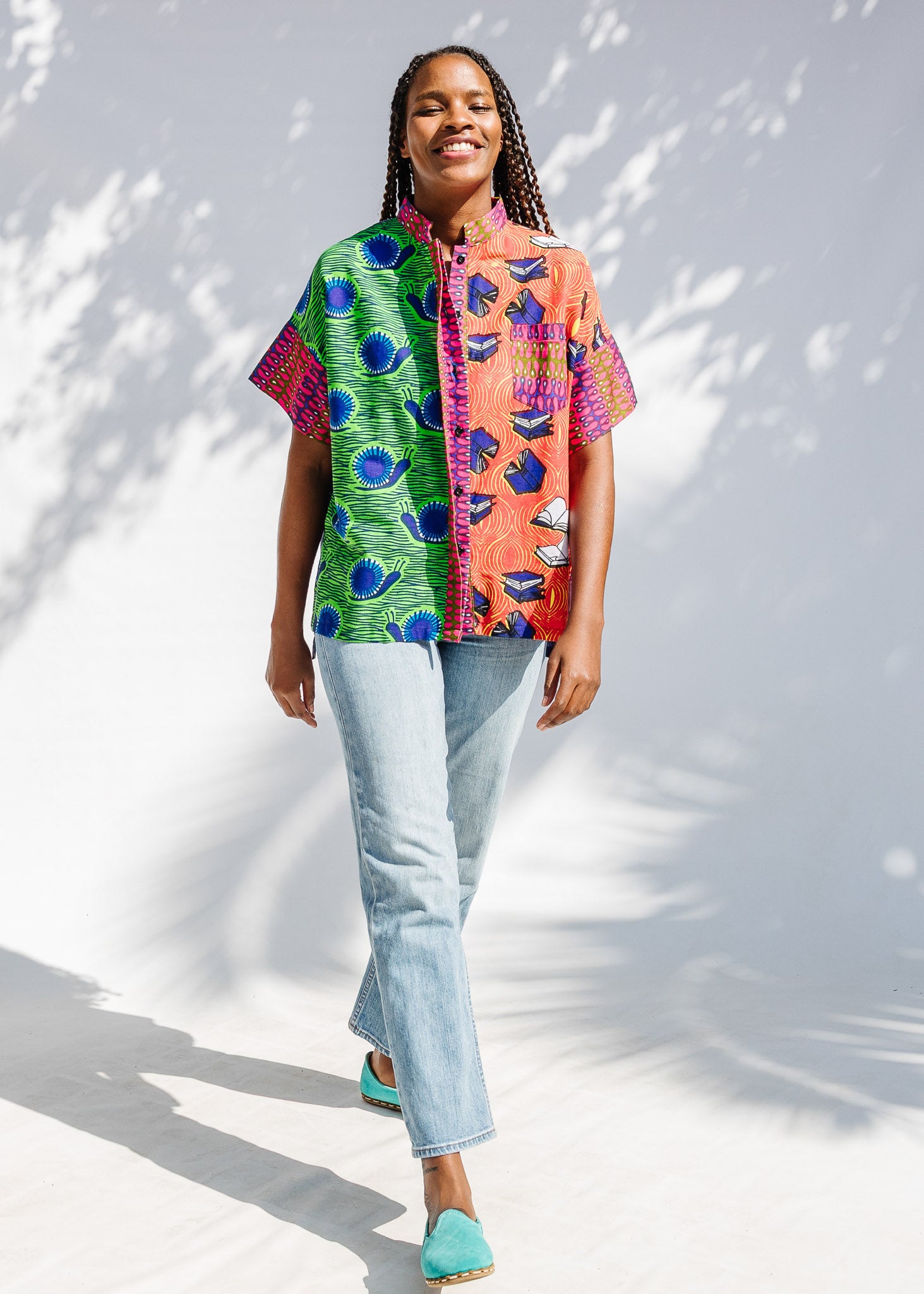Model wearing green, orange and pink multiprint shirt.