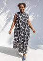 Model wearing black and white floral print, sleeveless dress.