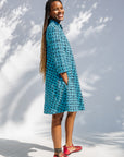 Model wearing blue and black squiggle print dress.