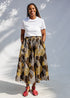 Model wearing brown leaf print culotte bottoms.