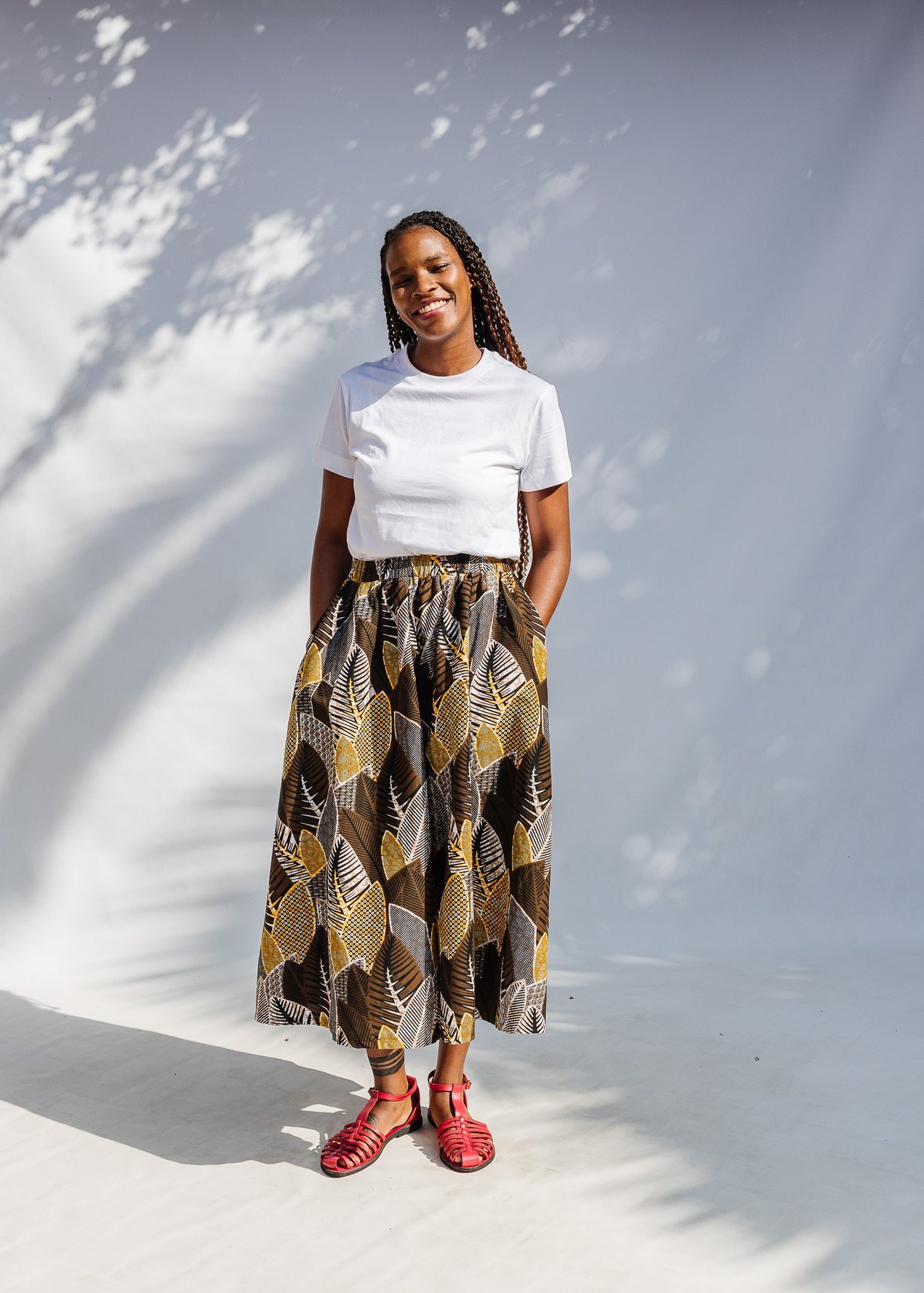 Model wearing brown leaf print culotte bottoms.