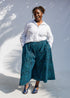 Model wearing white shirt and blue pants.