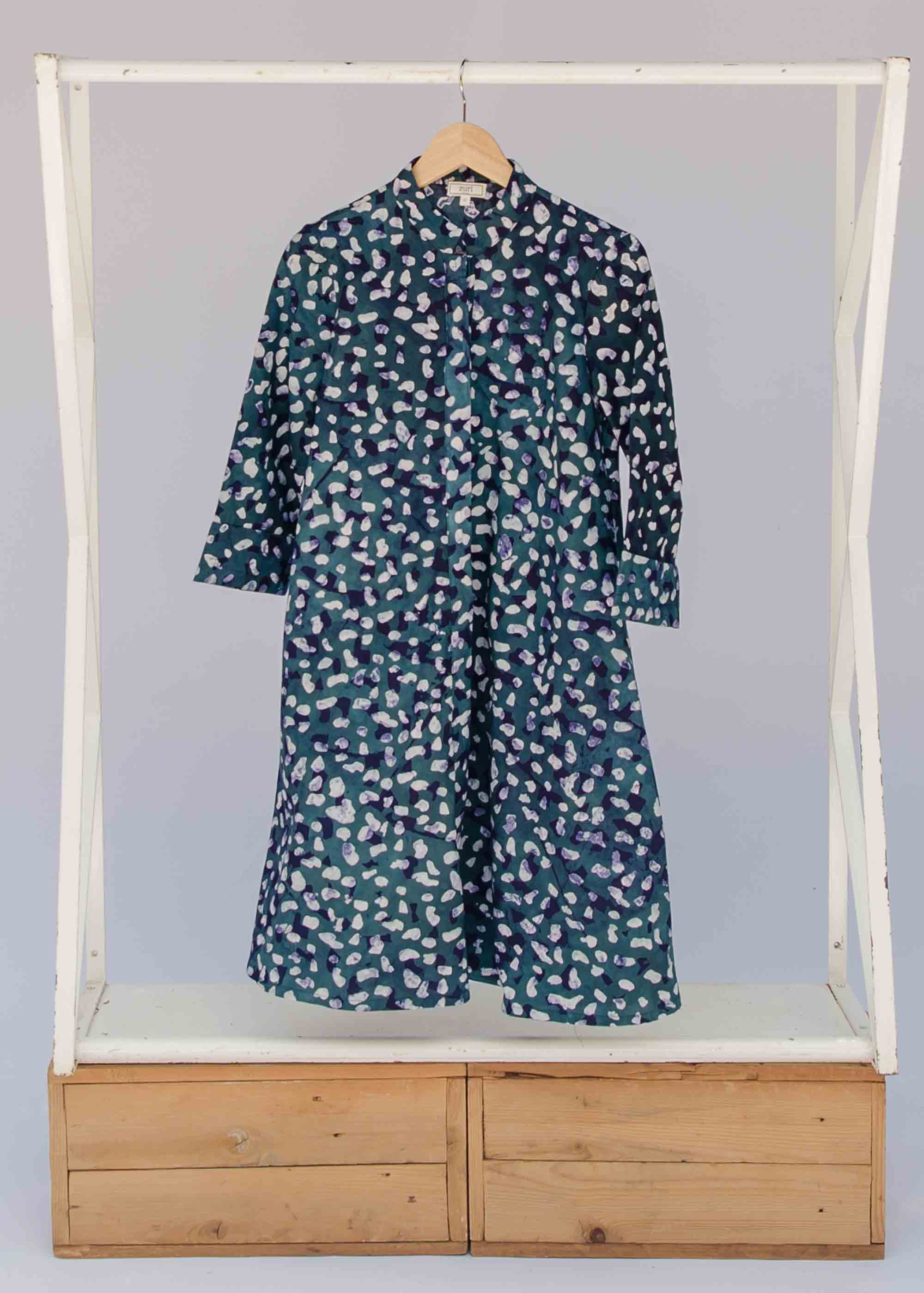 display of a green, white and navy polka dot design dress