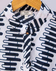 Display of white sleeveless dress with black and white zigzag print.