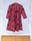 display of red dress with floral vine print.
