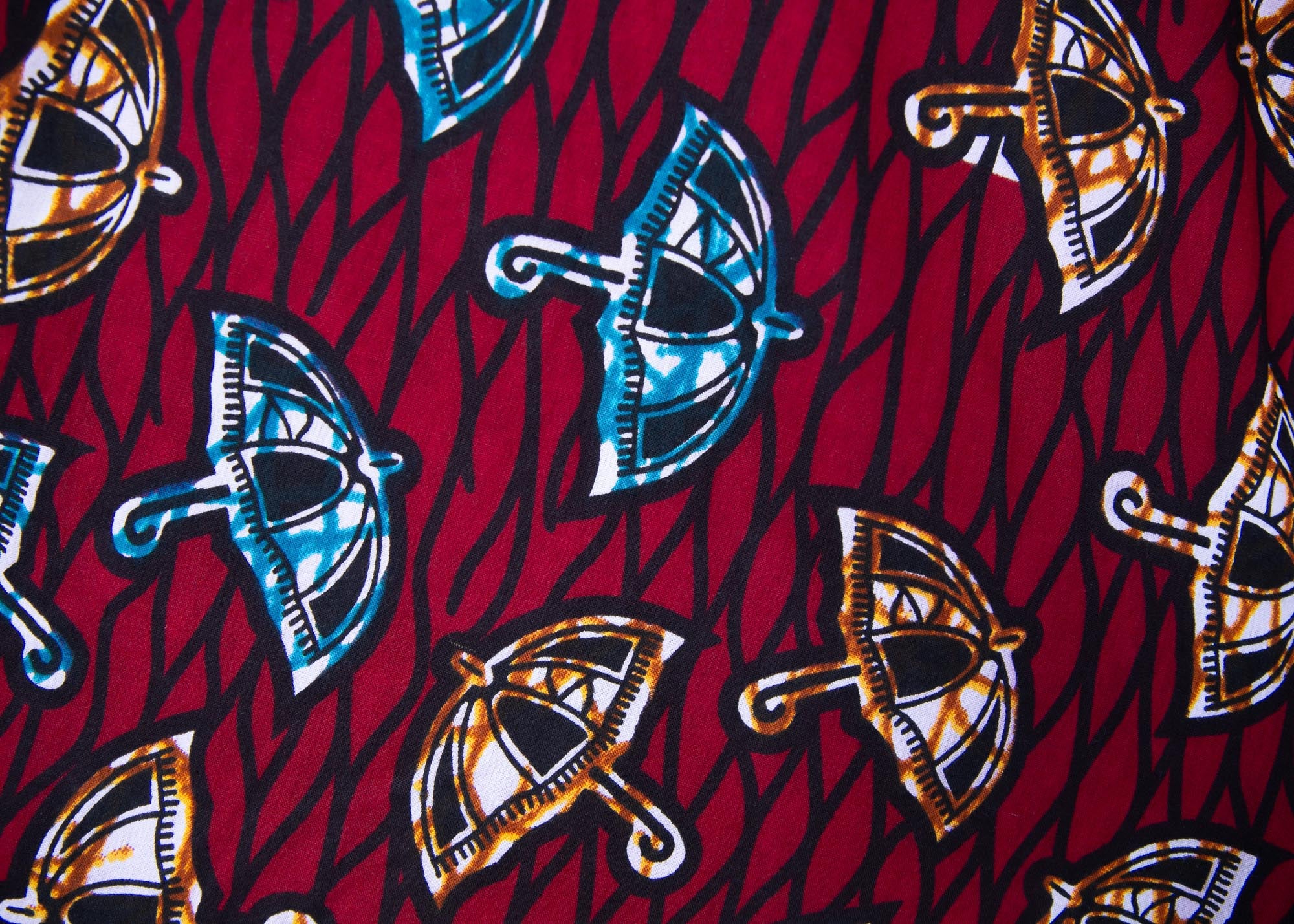 Close up display of red and black dress with umbrella design print