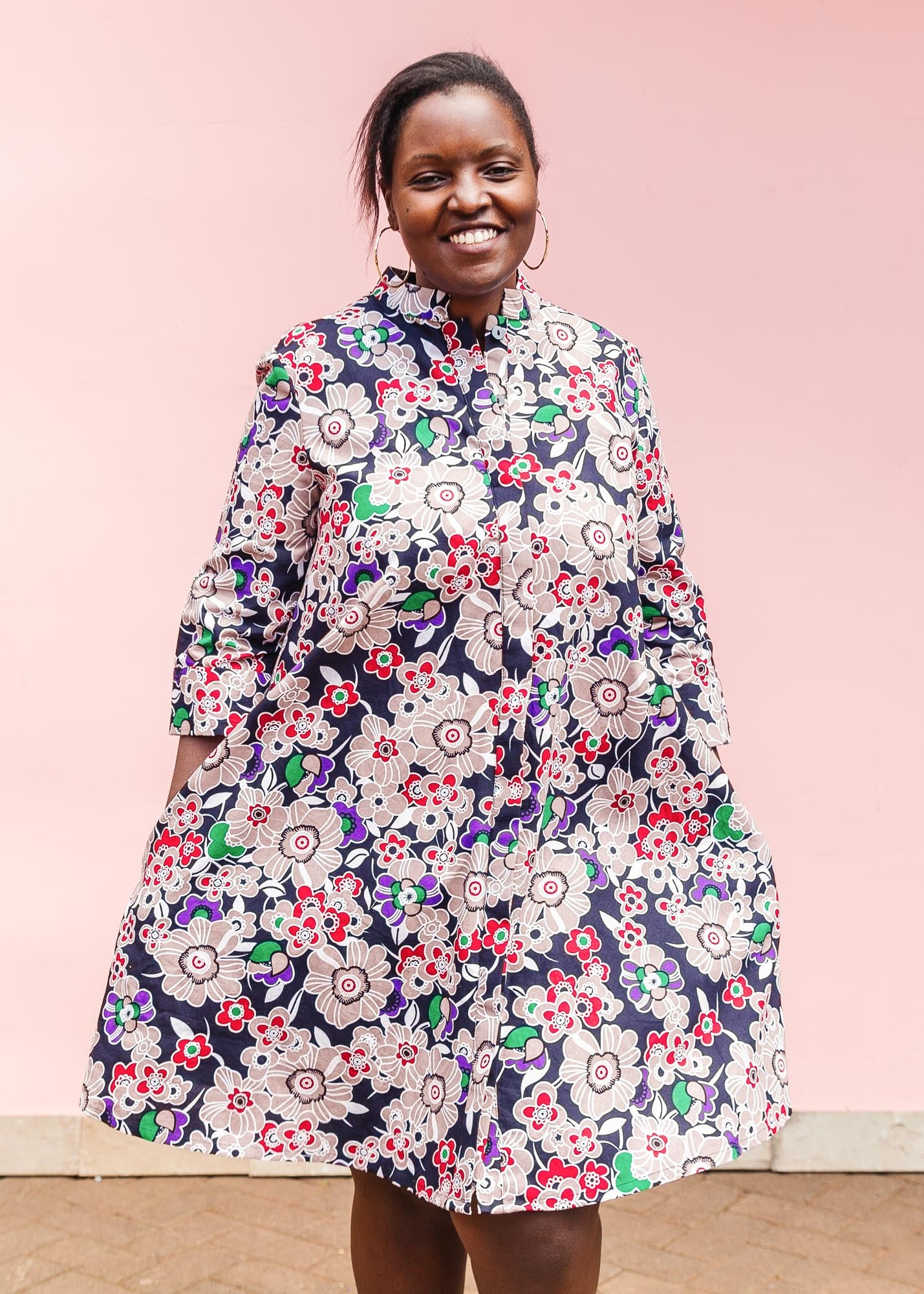 The model is wearing multi-colored floral print