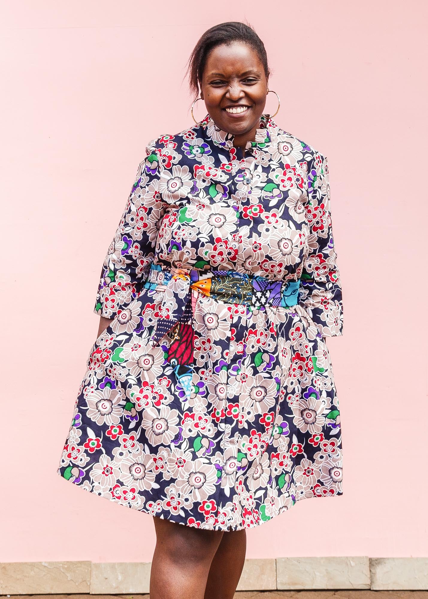 The model is wearing multi-colored floral print