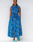 Model wearing blue dress with beige fish print.