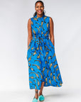 Model wearing blue dress with beige fish print.