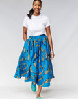 Model wearing white shirt with blue pants with beige fish print.