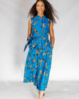 Model wearing blue dress with beige fish print.