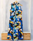 Display of blue dress with yellow, black, orange and white geometric print.