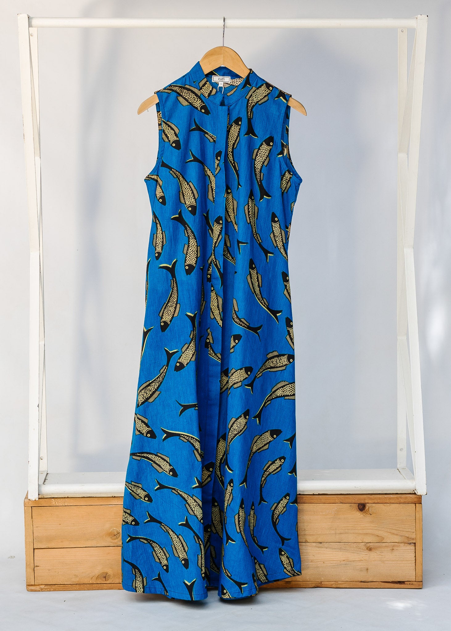 Display of blue dress with beige fish print.