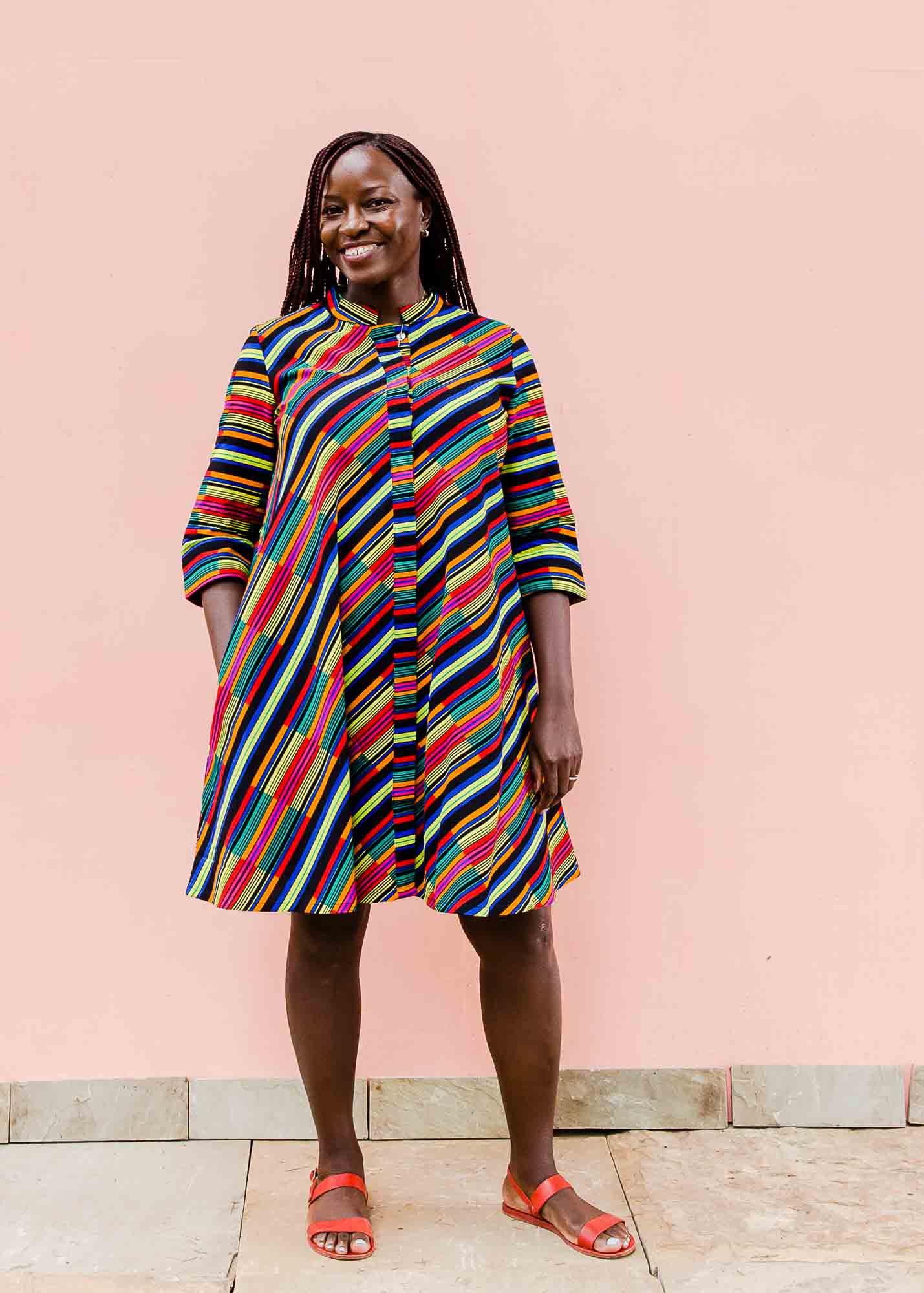 model wearing a rainbow striped dress