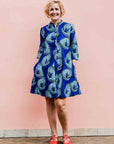 model wearing a blue lily design dress