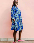 model wearing a blue lily design dress