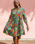 Model wearing colorful rainbow leaves print dress.