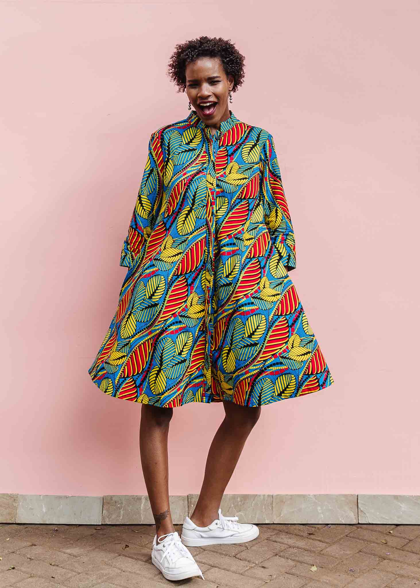 Model wearing colorful rainbow leaves print dress.