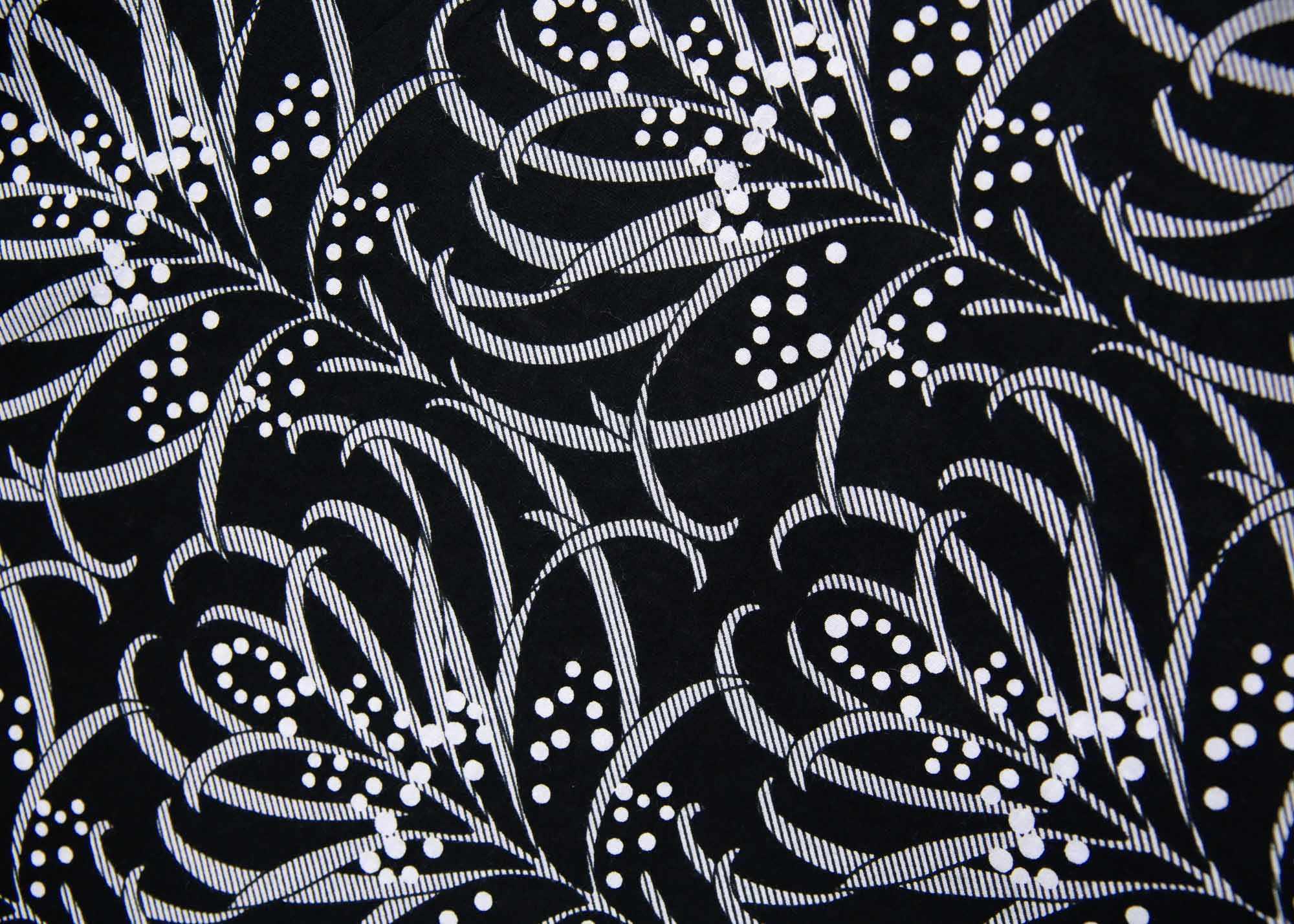 Close up display of white and black dress with floral print, fabric