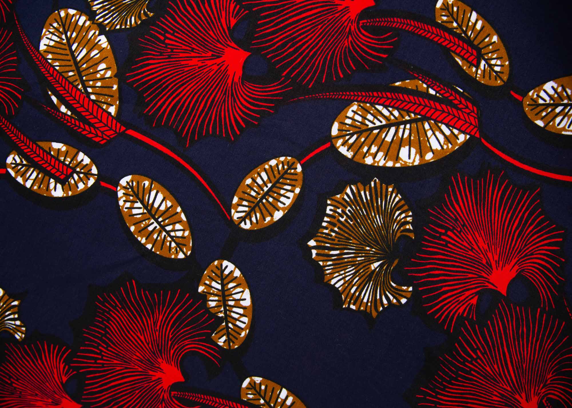 Close up of navy dress with red, white and orange floral print, fabric