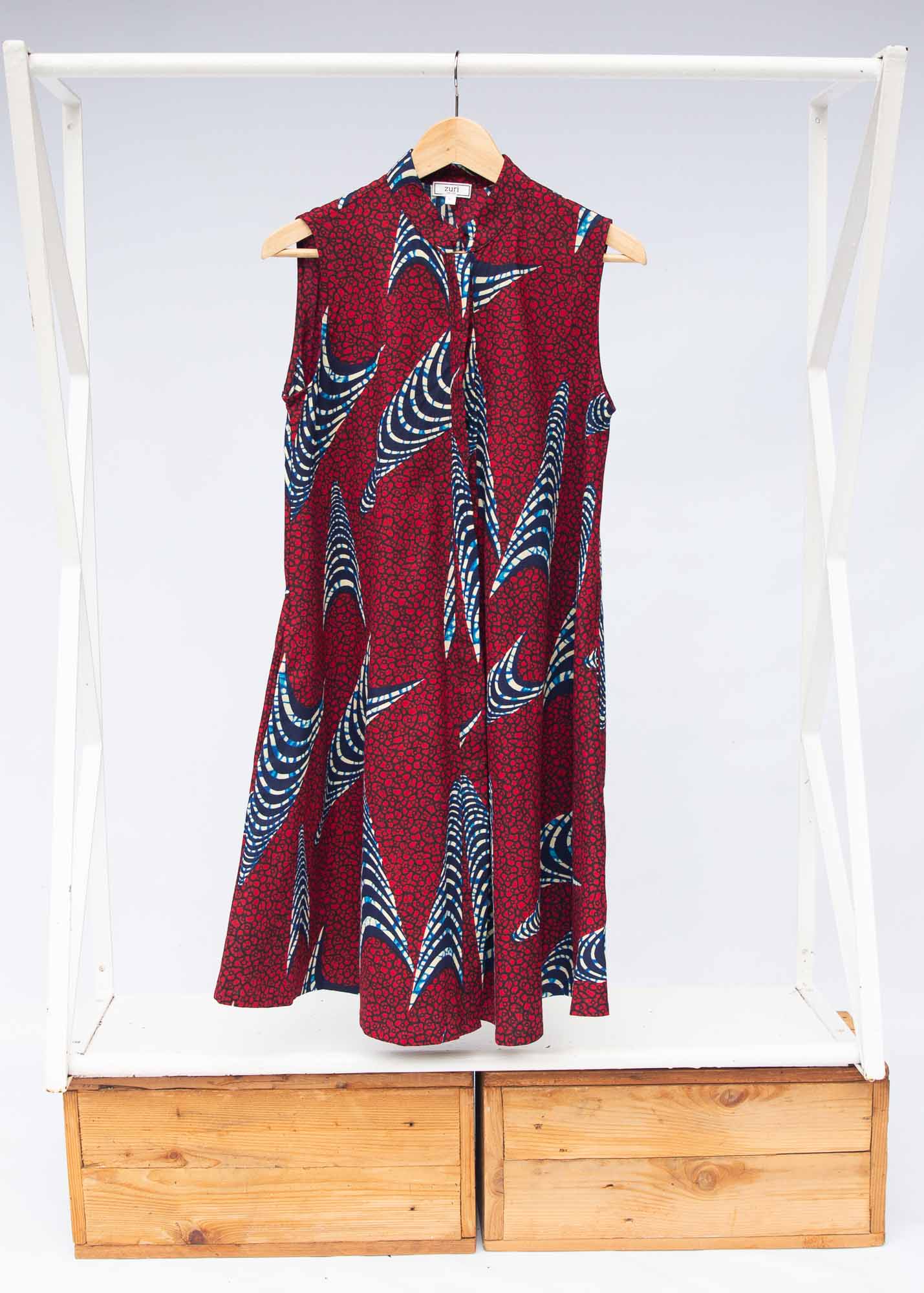 The display of red and black dress with navy blue and beige print