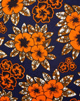 Close up display of navy dress with orange, brown, black and white floral print, fabric