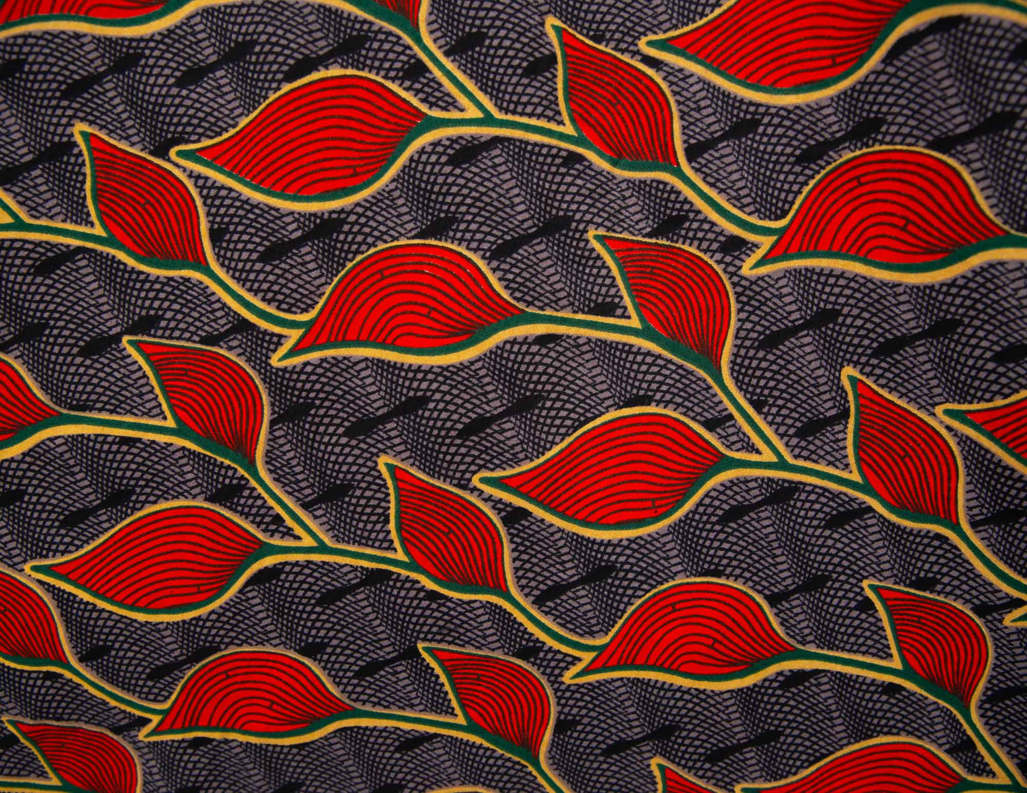 Close up display of grey dress with red, yellow and black leaf print, fabric