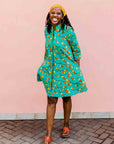 model wearing a teal, orange and yellow pod design dress