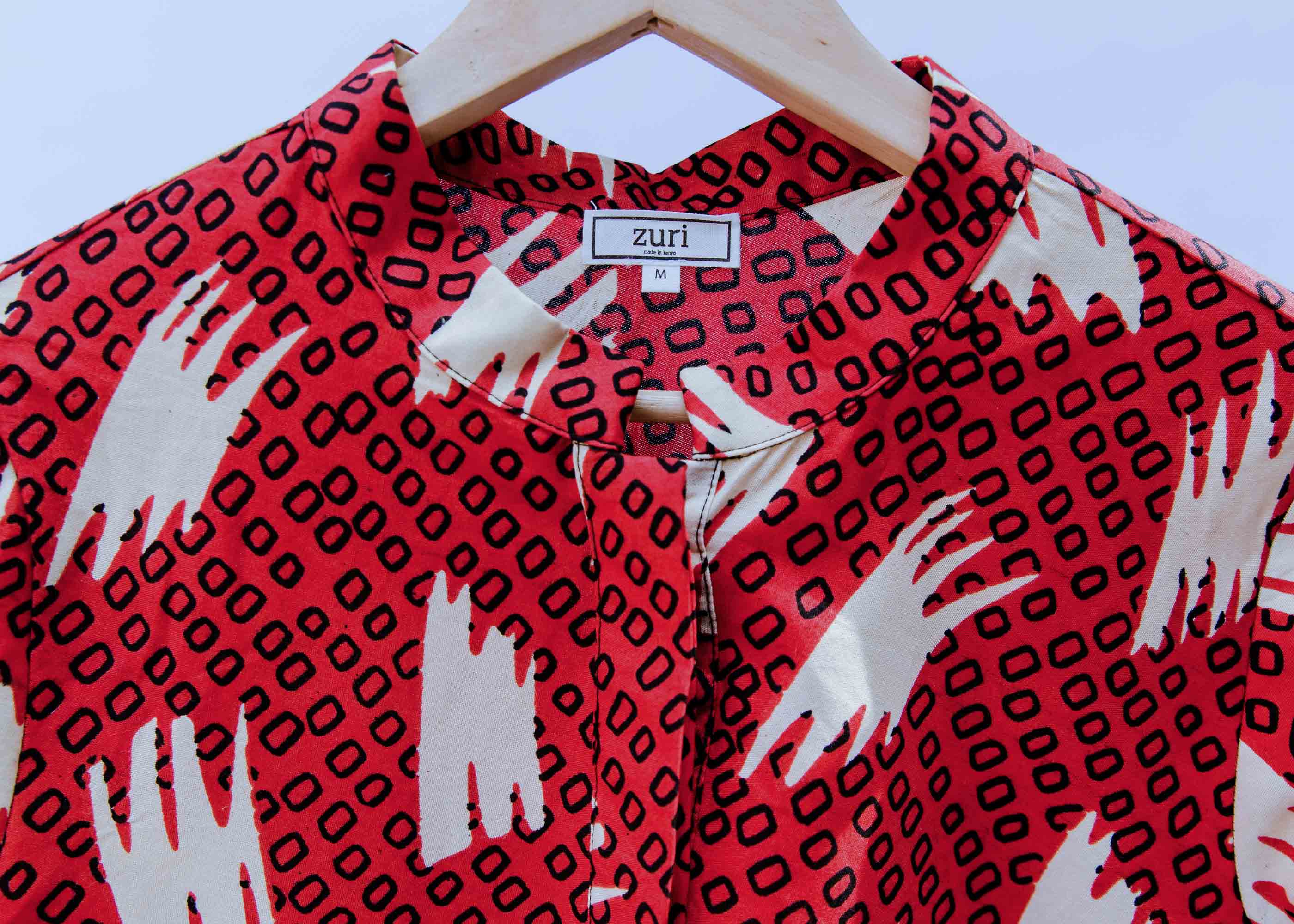 display of a red, white and black squiggle design dress
