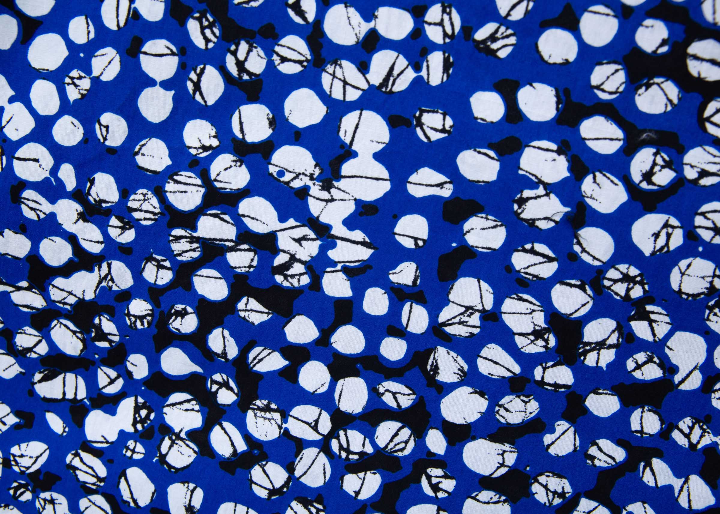 Close up display of blue dress with black and white abstract dots