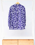 Display of long sleeve purple blouse with small with squares.